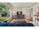 Cozy living room with hardwood floors, a large window, and comfortable furnishings at 5573 S Datura St, Littleton, CO 80120