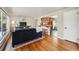 Bright living room featuring hardwood floors, an open layout, and access to the kitchen at 5573 S Datura St, Littleton, CO 80120