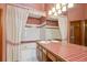 A charming bathroom featuring dual sinks, tile counter, and curtained tub at 2132 S Scranton Way, Aurora, CO 80014