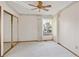A carpeted bedroom featuring large windows and mirrored closet at 2132 S Scranton Way, Aurora, CO 80014