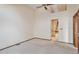 Bright bedroom featuring neutral carpet, ceiling fan, and adjoining bath at 2132 S Scranton Way, Aurora, CO 80014