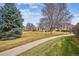 Charming exterior view of well-maintained building with green lawn and mature landscaping in neighborhood at 2132 S Scranton Way, Aurora, CO 80014