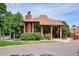 Charming brick clubhouse featuring expansive windows, attractive landscaping, and a welcoming entrance at 2132 S Scranton Way, Aurora, CO 80014
