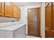 Functional laundry room complete with washer, dryer, and overhead storage at 2132 S Scranton Way, Aurora, CO 80014