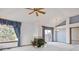 Cozy living room with a fireplace, large windows, and ceiling fan offers a relaxing atmosphere at 2132 S Scranton Way, Aurora, CO 80014
