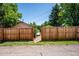 Backyard entrance through a wood fence showing pathway leading to an unknown location at 5549 S Greenwood St, Littleton, CO 80120