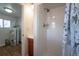 Modern bathroom featuring white tile in the shower and view of the water heater next to the vanity at 5549 S Greenwood St, Littleton, CO 80120