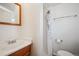 Bathroom with a wooden framed mirror and a shower-tub combo featuring a shower curtain with a floral motif at 5549 S Greenwood St, Littleton, CO 80120