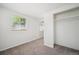 Bright bedroom featuring plush carpet, closet, and natural light from a large window at 5549 S Greenwood St, Littleton, CO 80120