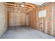 Clean unfinished garage interior featuring a door and window at 5549 S Greenwood St, Littleton, CO 80120