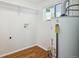 White walled laundry room with a water heater and wood look flooring at 5549 S Greenwood St, Littleton, CO 80120