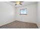 Bright bedroom featuring neutral carpet, ceiling fan, and a window for natural light at 12531 W Alameda Dr, Lakewood, CO 80228