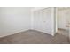 Bright bedroom features neutral carpet and closet for ample storage at 12531 W Alameda Dr, Lakewood, CO 80228