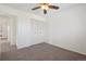 Bright bedroom features neutral carpet, ceiling fan, and closet for ample storage at 12531 W Alameda Dr, Lakewood, CO 80228