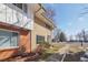 A bright turquoise door accents this charming townhouse with a well-kept front yard at 12531 W Alameda Dr, Lakewood, CO 80228