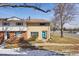 Charming townhouse featuring a striking turquoise door and a well-maintained lawn at 12531 W Alameda Dr, Lakewood, CO 80228