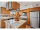 Renovated kitchen includes stainless steel appliances, granite countertops, and lots of wooden cabinets at 12531 W Alameda Dr, Lakewood, CO 80228