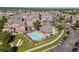 Aerial view of community with clubhouse, swimming pool, and surrounding residential buildings at 18661 E Water Dr # F, Aurora, CO 80013