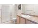 Bathroom featuring white tiling, large shower with glass doors, and vanity with sink at 18661 E Water Dr # F, Aurora, CO 80013