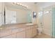 Bathroom featuring a large vanity, a mirror with vanity lighting, and shower-tub combo at 18661 E Water Dr # F, Aurora, CO 80013