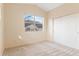 Bedroom featuring neutral paint, plush carpeting, and a closet with bifold doors at 18661 E Water Dr # F, Aurora, CO 80013