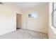 Image of a bedroom with neutral walls and carpet, a small window, and a light-colored door at 18661 E Water Dr # F, Aurora, CO 80013