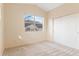 Neutral bedroom featuring a window and a closet at 18661 E Water Dr # F, Aurora, CO 80013