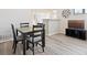 Open dining area with hardwood floors and bar top looking into kitchen at 18661 E Water Dr # F, Aurora, CO 80013