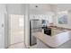 Bright kitchen featuring stainless steel appliances, white cabinets, and a breakfast bar at 18661 E Water Dr # F, Aurora, CO 80013