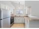 Bright kitchen featuring stainless steel appliances, white cabinets, and tiled floors at 18661 E Water Dr # F, Aurora, CO 80013