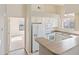 Bright kitchen with white cabinets, modern appliances, and convenient breakfast bar at 18661 E Water Dr # F, Aurora, CO 80013