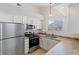 Bright kitchen featuring stainless steel appliances, white cabinets, and large window at 18661 E Water Dr # F, Aurora, CO 80013