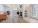 Open-concept living room boasts hardwood flooring, a fireplace, and seamless access to the kitchen and dining area at 18661 E Water Dr # F, Aurora, CO 80013