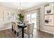 Bright dining room features a table for six and sliding glass doors at 9902 Cathay St, Commerce City, CO 80022