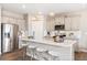 Modern kitchen with gray cabinets, white quartz countertops, and stainless steel appliances at 9902 Cathay St, Commerce City, CO 80022