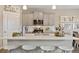 Modern kitchen with island, gray cabinets, and white quartz countertops at 9902 Cathay St, Commerce City, CO 80022