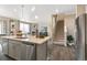 Modern kitchen island with stainless steel appliances and white countertops at 9902 Cathay St, Commerce City, CO 80022