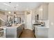 Modern kitchen with gray cabinets, white quartz countertops, and stainless steel appliances at 9902 Cathay St, Commerce City, CO 80022