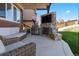 Outdoor entertaining area featuring a built-in grill, fireplace, seating, and lush green grass at 3745 Spanish Oaks Trl, Castle Rock, CO 80108