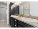 A modern bathroom with dual sinks, granite countertop, and glass shower enclosure at 3745 Spanish Oaks Trl, Castle Rock, CO 80108