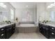 The primary bathroom features dual vanities, granite counters and a relaxing soaking tub with natural light from the window at 3745 Spanish Oaks Trl, Castle Rock, CO 80108