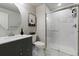 This elegant bathroom has a sleek vanity, round mirror, and modern glass-enclosed shower for a spa-like experience at 3745 Spanish Oaks Trl, Castle Rock, CO 80108