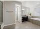 Bright bathroom featuring a soaking tub, shower, vanity, and tiled floors at 3745 Spanish Oaks Trl, Castle Rock, CO 80108