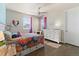 Bright bedroom featuring hardwood floors, ceiling fan, large window, and closet at 3745 Spanish Oaks Trl, Castle Rock, CO 80108