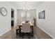 Bright dining room featuring hardwood floors, a modern chandelier, and a large window providing ample natural light at 3745 Spanish Oaks Trl, Castle Rock, CO 80108