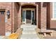 Charming front door framed by brick, sidelights, and decorative accents creating an inviting entrance to the home at 3745 Spanish Oaks Trl, Castle Rock, CO 80108