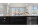Kitchen island with a granite countertop and sink, complemented by an elegant dining area at 3745 Spanish Oaks Trl, Castle Rock, CO 80108