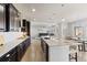 Open-concept kitchen with granite countertops, island seating, and seamless flow to the living area at 3745 Spanish Oaks Trl, Castle Rock, CO 80108