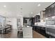 Modern kitchen featuring an island with seating, stainless steel appliances, and dark cabinetry at 3745 Spanish Oaks Trl, Castle Rock, CO 80108