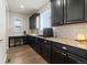 Kitchen featuring dark cabinets, stainless steel appliances, and a built-in desk area at 3745 Spanish Oaks Trl, Castle Rock, CO 80108